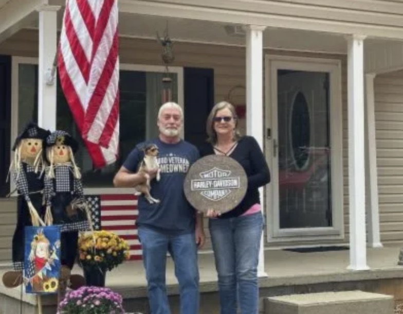 picture of Gregory L. in front of a house