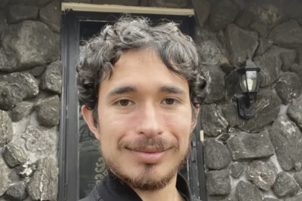 picture of Louis E. in front of a house